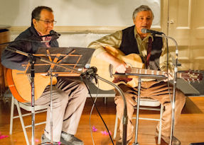 Photo of two people playing guitar